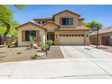 Inviting two-story home with desert landscaping, a two-car garage, and a basketball hoop on a sunny day at 32901 N Hidden Canyon Dr, San Tan Valley, AZ 85144