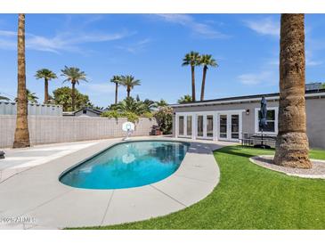 A stunning private pool with basketball hoop, patio and palm trees, perfect for entertaining at 4216 N 20Th St, Phoenix, AZ 85016