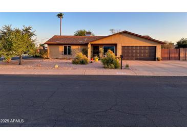 Charming single-story home with a two-car garage, desert landscaping, and a welcoming entrance at 4901 W Corrine Dr, Glendale, AZ 85304