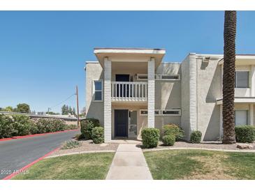 Two-story condo featuring a well-manicured lawn, mature trees, and a private balcony at 610 E Montebello Ave # 46, Phoenix, AZ 85012