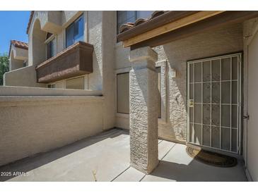 Exterior shot featuring a covered entryway with security screen door and a private patio area at 839 S Westwood -- # 170, Mesa, AZ 85210