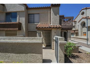 Inviting condo exterior with a private courtyard and gate, offering a cozy and secure entrance at 839 S Westwood -- # 170, Mesa, AZ 85210
