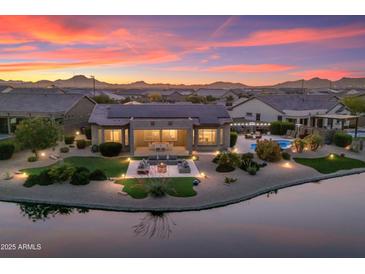 Beautiful single-story home with desert landscaping, pool, and outdoor living space on water at 16683 S 180Th Dr, Goodyear, AZ 85338
