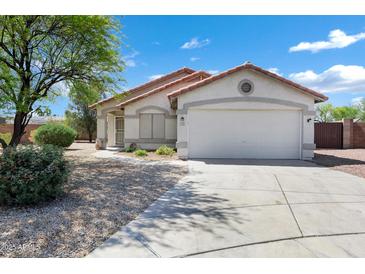 Charming single-story home with a well-manicured front yard and a two-car garage at 1120 S Valley Dr, Apache Junction, AZ 85120