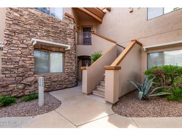 Inviting condo exterior with stone accents and meticulously maintained desert landscaping at 16801 N 94Th St # 2056, Scottsdale, AZ 85260