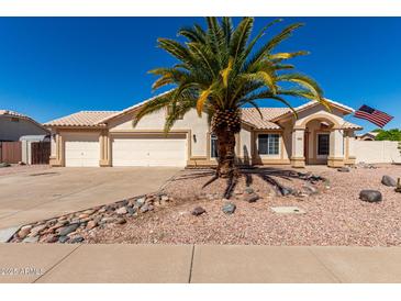 Charming single-story home with a three car garage, desert landscaping and a mature palm tree at 2356 N Glenview --, Mesa, AZ 85213