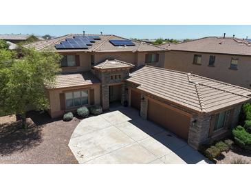Stunning two-story home featuring a three-car garage, solar panels, and attractive stone accents at 26529 N 167Th Ave, Surprise, AZ 85387