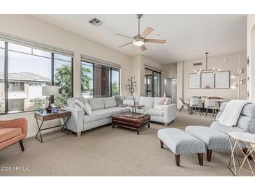 Expansive living room featuring a plush sectional sofa, leather ottoman, and sun-filled windows at 2989 N 44Th St # 3044, Phoenix, AZ 85018