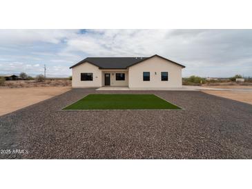 Charming single-story home featuring desert landscaping, gray gravel, and a cozy front lawn square at 3880 S 331St Ave, Tonopah, AZ 85354