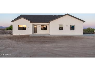 New construction home with white exterior, and grey trim with large front yard at 3880 S 331St Ave, Tonopah, AZ 85354