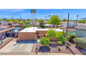Aerial view of the property highlighting landscaping, two-car garage, and residential neighborhood at 6401 N 82Nd Way, Scottsdale, AZ 85250