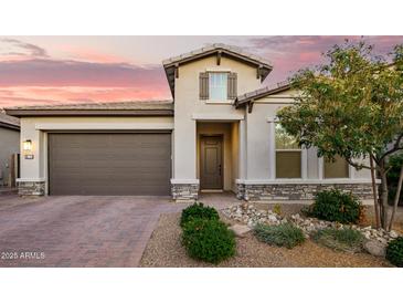 Charming single-Gathering home featuring a well-manicured front yard and a two-car garage at 18025 N 65Th Pl, Phoenix, AZ 85054