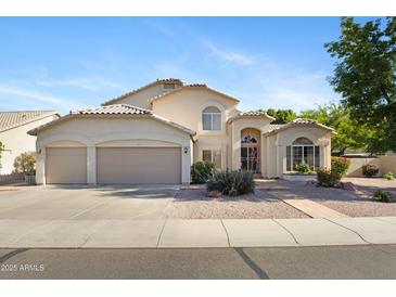 Charming two-story home featuring a three-car garage and a well-maintained, drought-resistant front yard at 1975 E Chilton Dr, Tempe, AZ 85283