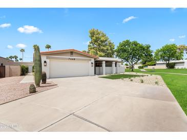 Charming single-story home with a well-manicured front yard, two car garage and desert landscaping at 7648 N Via Del Paraiso --, Scottsdale, AZ 85258