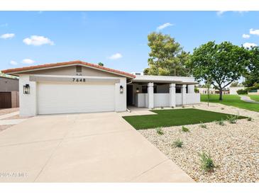 Charming single-story home featuring a two-car garage and well-maintained desert landscaping at 7648 N Via Del Paraiso --, Scottsdale, AZ 85258