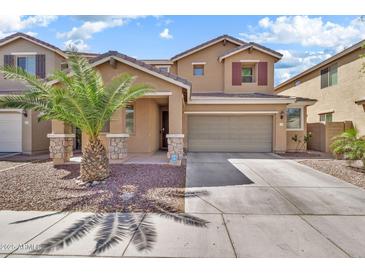 Inviting two-story home showcasing a well-manicured front yard and a convenient two-car garage at 121 W Hackberry Dr, Chandler, AZ 85248