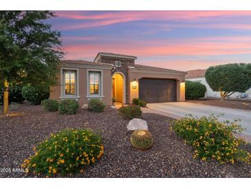 Charming single-story home with a well-manicured front yard and desert landscaping at 12780 W Desert Vista Trl, Peoria, AZ 85383