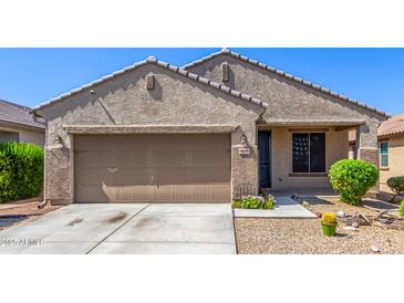 Charming single-story home showcasing a well-manicured lawn and a neutral-toned exterior at 18008 W Tina Ln, Surprise, AZ 85387