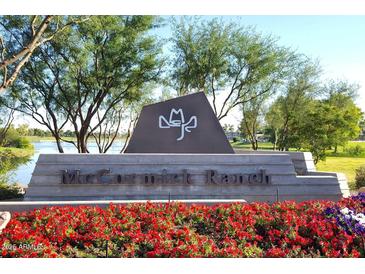 Community entrance sign for McCormick Ranch, with lush landscaping and a peaceful lake in the background at 8306 E Via De Dorado --, Scottsdale, AZ 85258