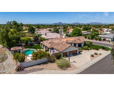 Desert home with a private pool, landscaped yard, tile roof and attached garage at 10205 E Corrine Dr, Scottsdale, AZ 85260