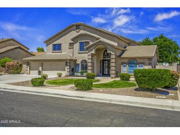Charming two-story home with landscaped front yard and a three car garage, perfect for suburban living at 112 E Joseph Way, Gilbert, AZ 85295