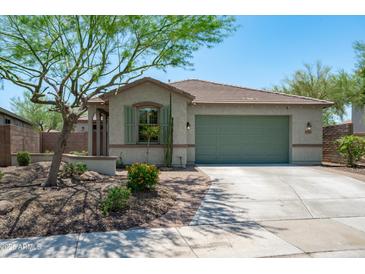 Charming single-story home featuring a low-maintenance yard, a two-car garage and attractive desert landscaping at 12727 W Lowden Rd, Peoria, AZ 85383
