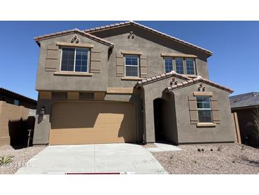 Beautiful two-story home with a two-car garage, desert landscaping, and neutral colors at 13294 W Eagle Feather Rd, Peoria, AZ 85383