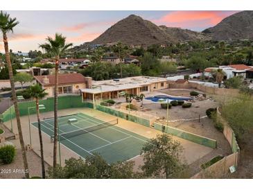 Expansive backyard with private pool, tennis court, and mountain views in this lovely estate at 4744 E Foothill Dr, Paradise Valley, AZ 85253