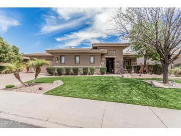 Beautiful front yard featuring a manicured lawn, desert landscaping, and a charming, modern exterior at 5291 S Bradshaw Pl, Chandler, AZ 85249