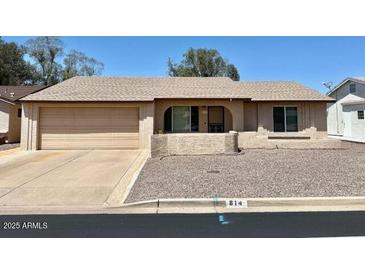 Single story home features a spacious garage, desert landscaping, and a neutral color palette at 814 S 80Th St, Mesa, AZ 85208