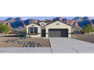 Inviting single-story home with desert landscaping and a two-car garage against a mountain backdrop at 1360 W Hess Ave, Coolidge, AZ 85128