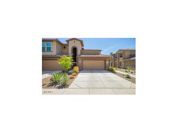Charming townhome featuring a private garage and well-maintained landscaping for an inviting curb appeal at 2425 W Bronco Butte Trl # 2028, Phoenix, AZ 85085