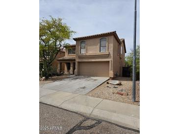 Two-story home features neutral stucco, tile roof, two car garage and desert landscaping at 2514 W Big Oak St, Phoenix, AZ 85085