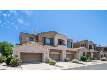 Attractive townhome featuring desert landscaping, attached garages, and a private balcony at 3131 E Legacy Dr # 2055, Phoenix, AZ 85042