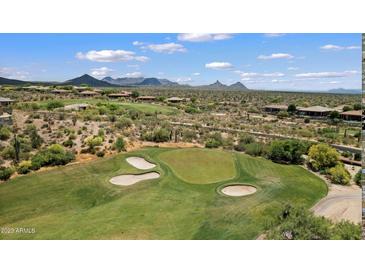 Picturesque golf course with lush green fairways and sand traps, set against a backdrop of mountains and desert landscape at 34457 N Legend Trail Pkwy # 1013, Scottsdale, AZ 85262