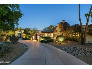Stunning home exterior featuring a long driveway and beautiful landscape at twilight at 3901 E San Miguel Ave, Paradise Valley, AZ 85253