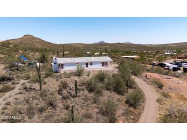 This well-maintained home offers desert views and easy access to hiking trails at 49039 N 24Th Ave, New River, AZ 85087