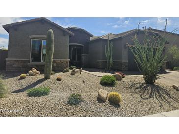 Charming home featuring desert landscaping, including cacti and drought-tolerant plants at 5637 E Lonesome Trl, Cave Creek, AZ 85331