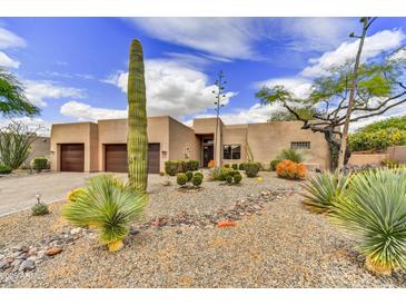 Charming desert home with a well-kept yard, native plants, and a three car garage at 9780 E Gamble Ln, Scottsdale, AZ 85262