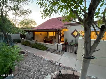 Charming home with red tile roof, covered patio, landscaped front yard, and welcoming entrance at 13636 N Hamilton Dr # 101, Fountain Hills, AZ 85268