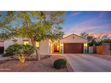Charming home featuring manicured landscaping, a two-car garage, and a welcoming entrance at 16229 W Berkeley Rd, Goodyear, AZ 85395