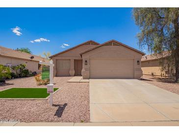Charming single-story home featuring a neutral color scheme, well-maintained landscaping, and an attached two-car garage at 16274 N 138Th Ln, Surprise, AZ 85374