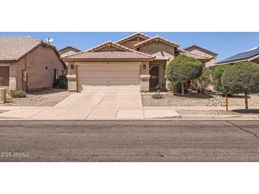 Charming single-level home featuring a two-car garage and desert landscaping at 17244 W Mohave St, Goodyear, AZ 85338