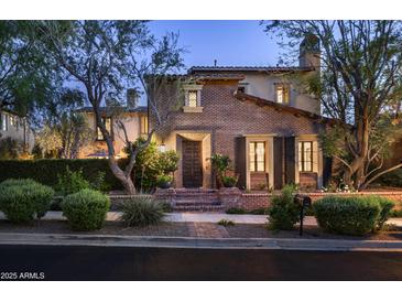 Charming brick home with meticulously landscaped front yard and inviting entrance at 19922 N 101St Pl, Scottsdale, AZ 85255