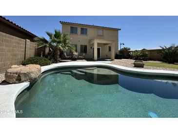 Gorgeous swimming pool and patio area in a lush, green backyard. Great for outdoor entertaining at 20426 N Alma Dr, Maricopa, AZ 85138