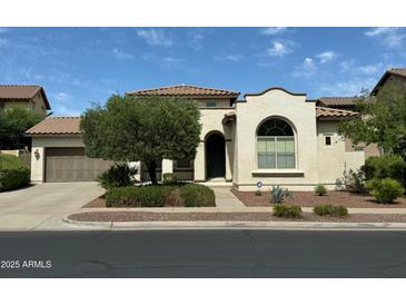 Charming single-Gathering home features a well-maintained lawn and desert landscaping and a tile roof at 20472 W Daniel Pl, Buckeye, AZ 85396