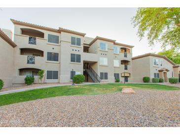 Multi-story apartment building featuring stucco siding, private balconies, and well-maintained landscaping at 3236 E Chandler Blvd # 3031, Phoenix, AZ 85048