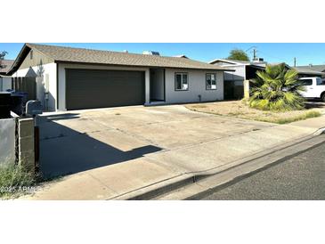 Charming single-story home with a well-maintained front yard and a two-car garage at 344 E Jacaranda St, Mesa, AZ 85201