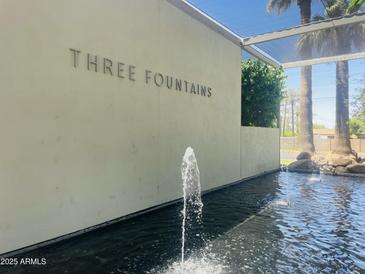 A tranquil water feature at Three Fountains with palm trees, creating a serene and inviting atmosphere at 4411 N 40Th St # 59, Phoenix, AZ 85018