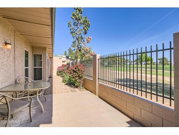 A lovely back patio featuring a table and chairs with a view of the golf course at 4531 W Continental Dr, Glendale, AZ 85308